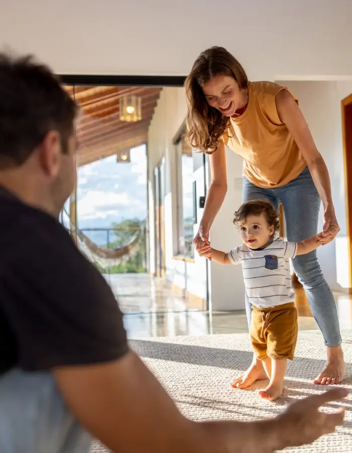Parent helping child take first steps