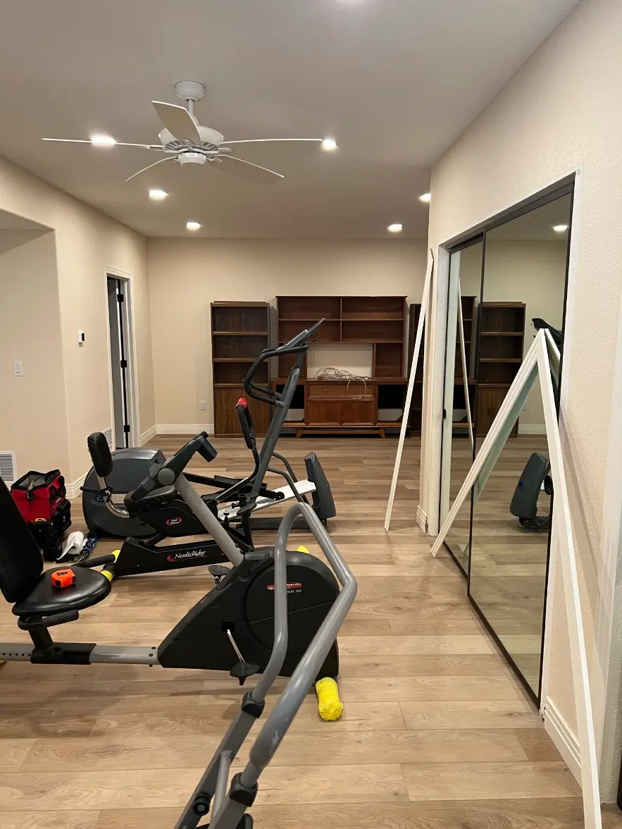 Home gym with mirrors and equipment