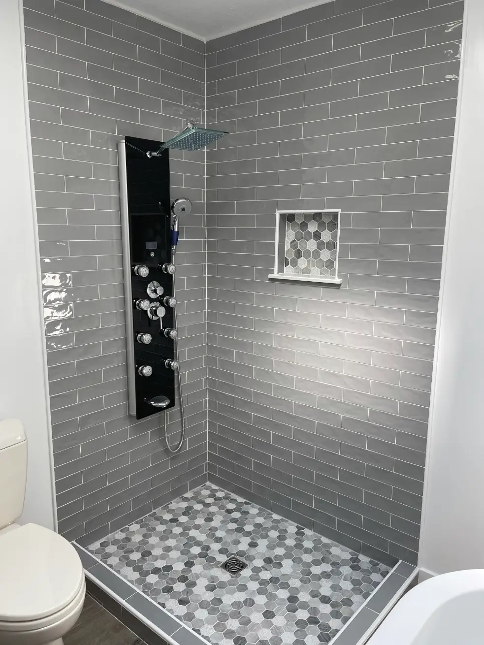 Modern shower with sleek gray tiles