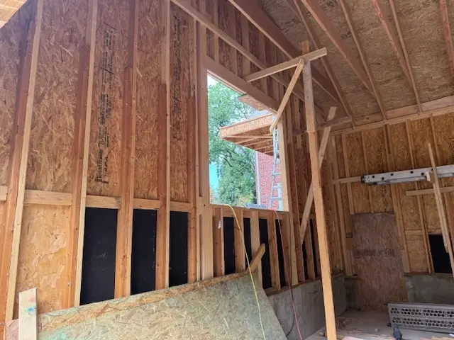 Framed garage interior under construction.